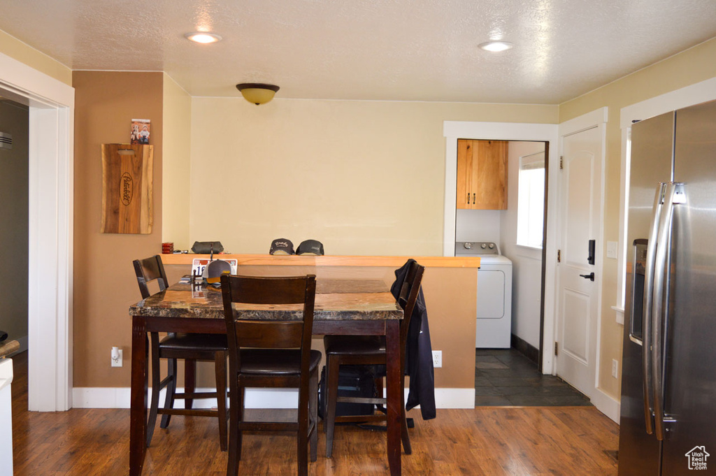 Dining area with dark wood-style flooring, recessed lighting, washer / clothes dryer, and baseboards