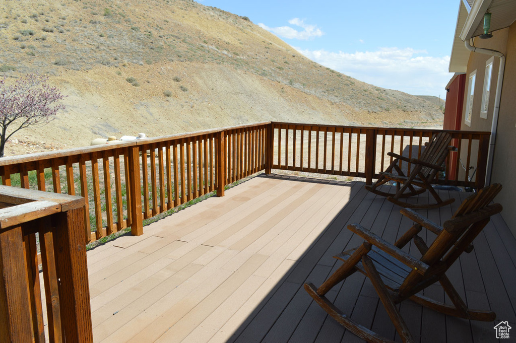 Wooden terrace featuring a mountain view