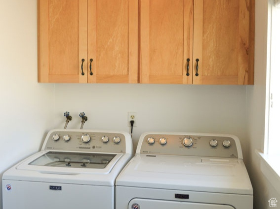 Washroom with cabinet space and separate washer and dryer