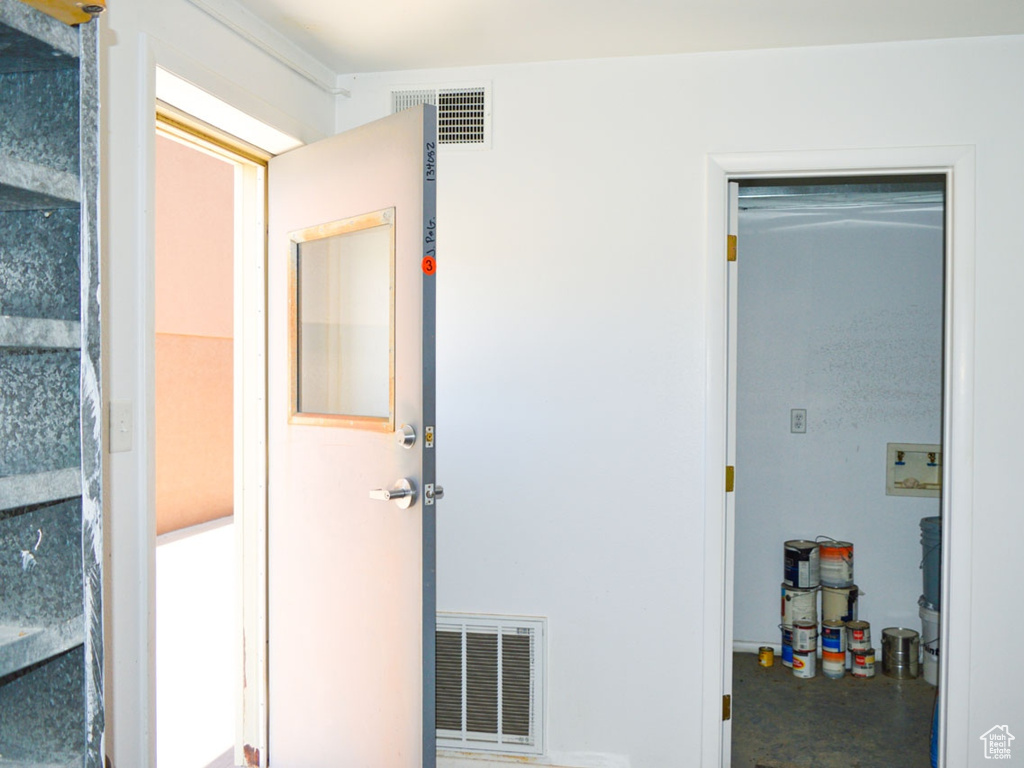 Interior space featuring finished concrete flooring and visible vents