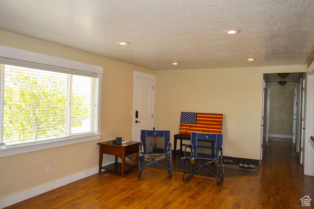 Sitting room featuring baseboards, recessed lighting, wood finished floors, and a textured ceiling