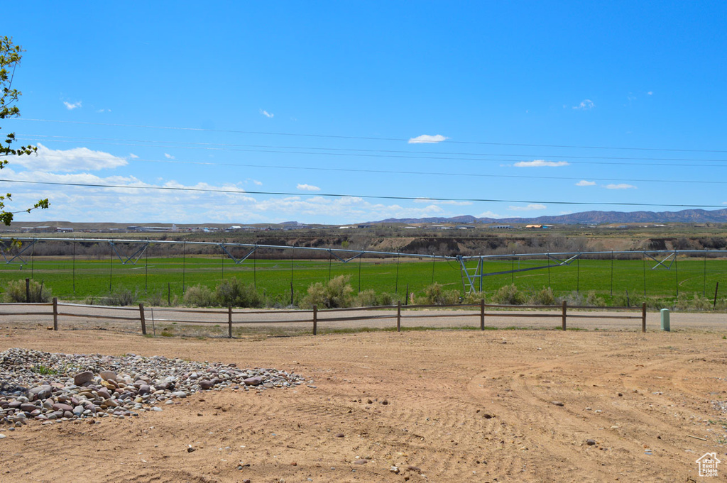 View of yard with a mountain view, a rural view, and fence