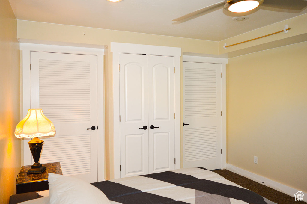 Carpeted bedroom featuring a closet, ceiling fan, and baseboards