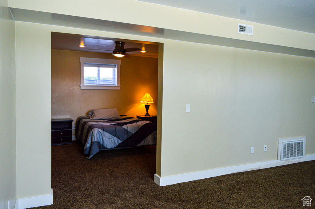 Carpeted bedroom featuring visible vents and baseboards