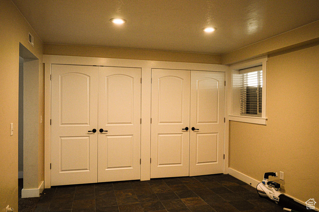 Unfurnished bedroom with baseboards, recessed lighting, visible vents, and multiple closets