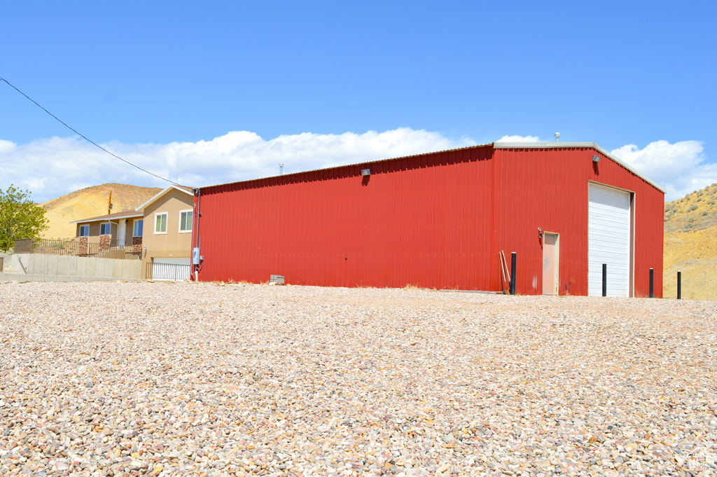 View of pole building featuring fence