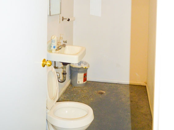 Half bath with visible vents, toilet, and a sink