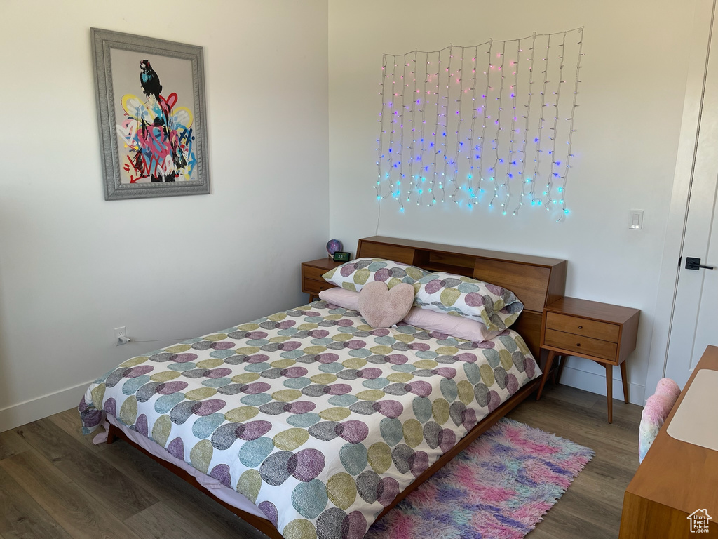 Bedroom featuring wood finished floors and baseboards