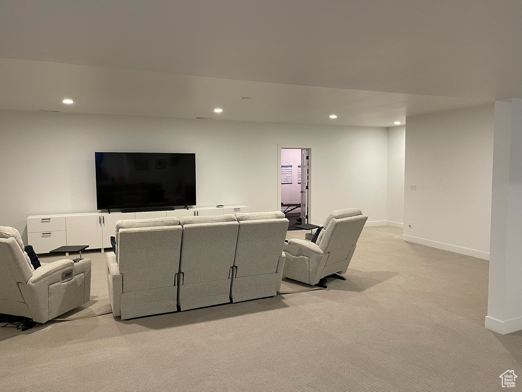 Living area featuring light colored carpet, recessed lighting, and baseboards