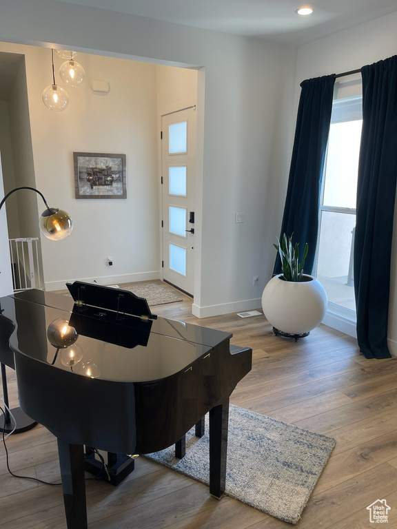 Interior space with a wealth of natural light, wood finished floors, and baseboards