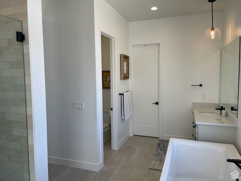 Full bathroom with a bathing tub, baseboards, toilet, recessed lighting, and vanity