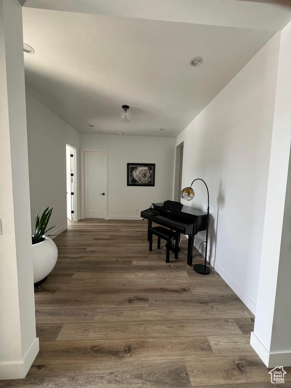 Corridor featuring recessed lighting, baseboards, and wood finished floors
