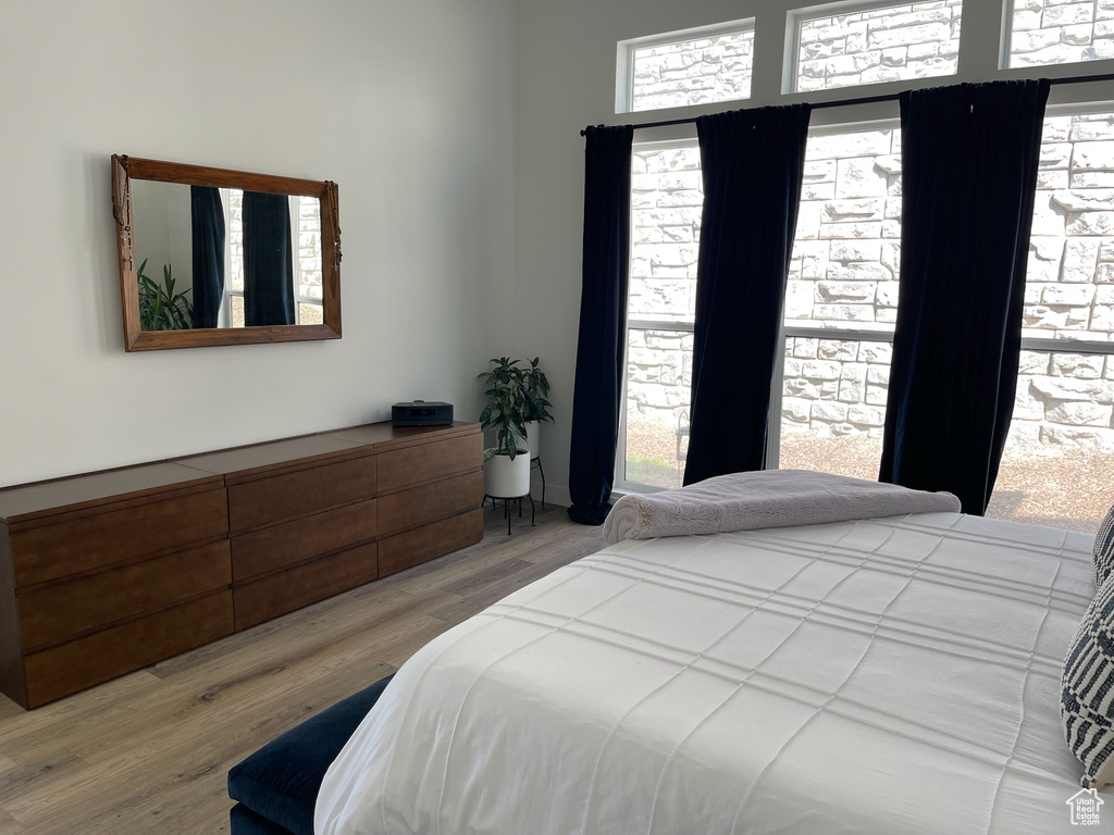 Bedroom featuring wood finished floors and multiple windows