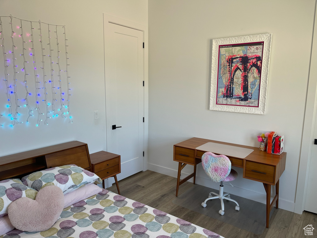 Bedroom with baseboards and wood finished floors
