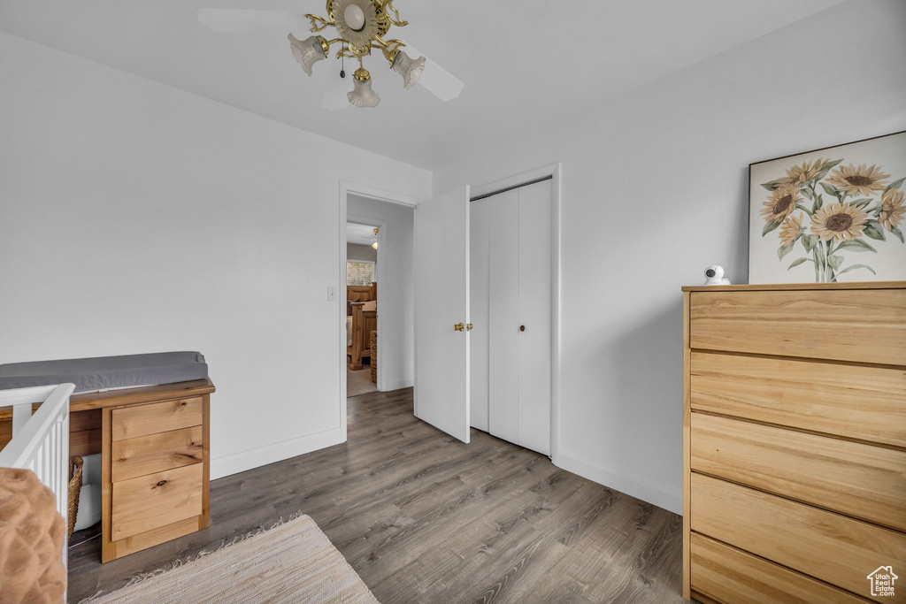 Office area featuring baseboards, ceiling fan, and wood finished floors