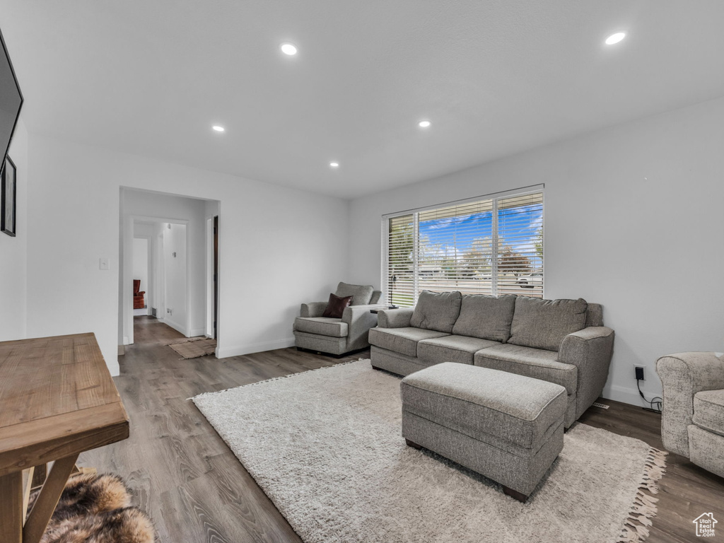 Living area with recessed lighting, baseboards, and wood finished floors