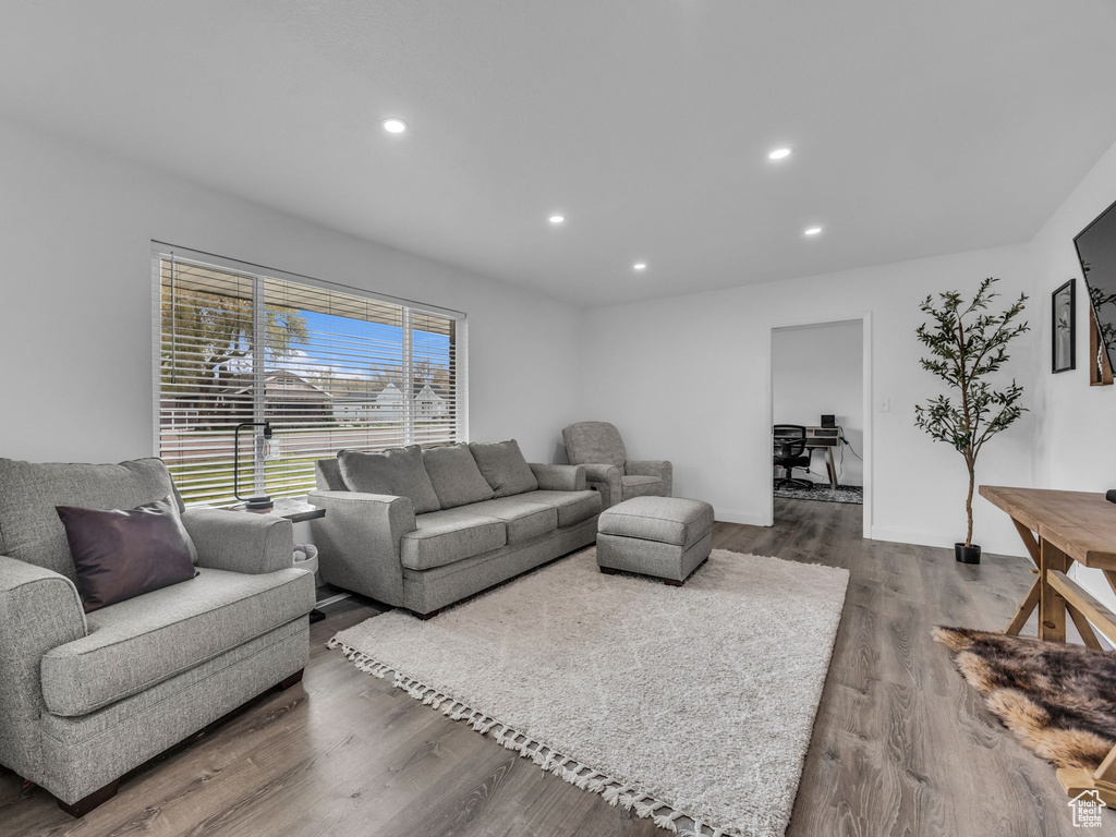 Living area featuring baseboards, recessed lighting, and dark wood-style floors