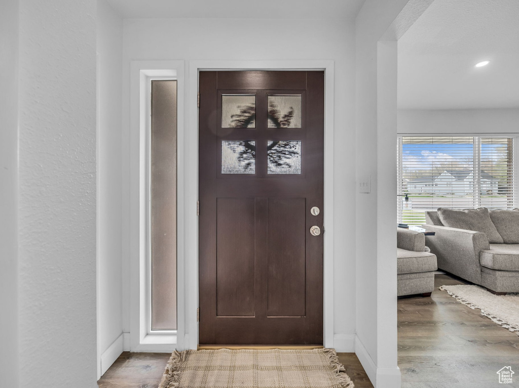 Foyer featuring baseboards, recessed lighting, and wood finished floors