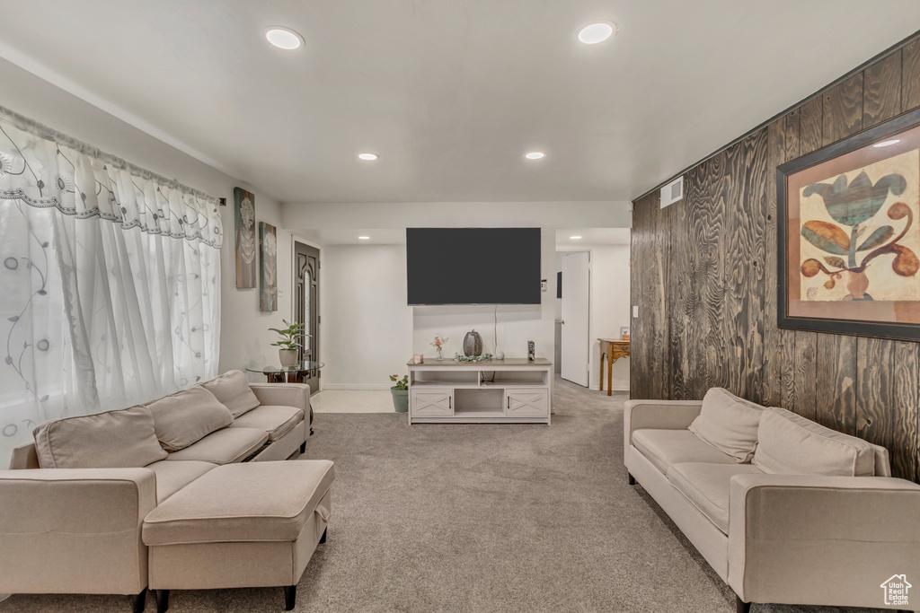 Carpeted living area featuring visible vents and recessed lighting