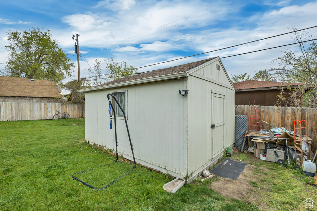 View of shed with a fenced backyard