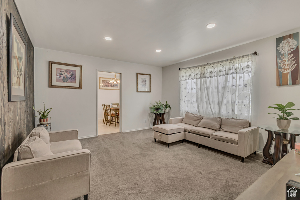 Living area with baseboards, recessed lighting, a notable chandelier, and carpet flooring