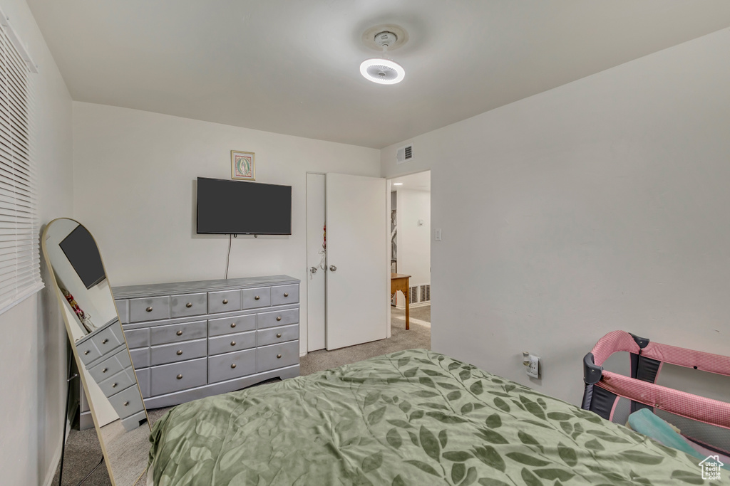Carpeted bedroom featuring visible vents