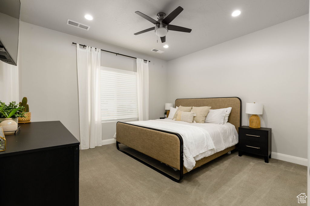 Bedroom featuring light colored carpet, baseboards, recessed lighting, and a ceiling fan