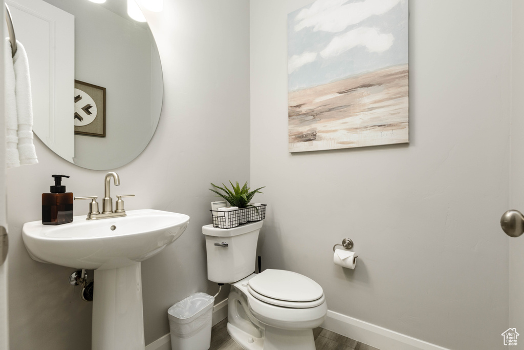 Bathroom with toilet and baseboards