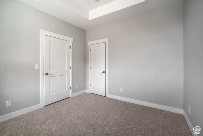 Unfurnished bedroom with baseboards and carpet floors