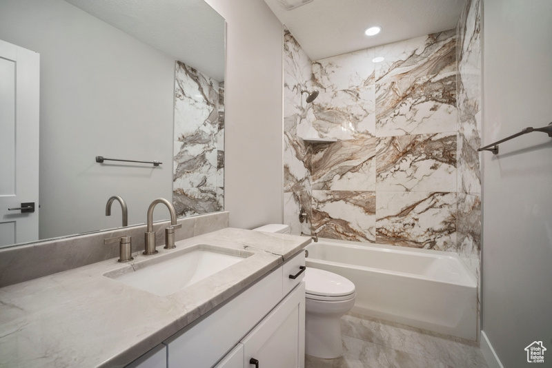 Full bathroom featuring toilet, recessed lighting, shower / bath combination, vanity, and marble finish floor