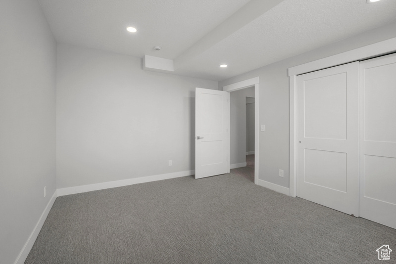 Unfurnished bedroom with recessed lighting, carpet floors, and baseboards