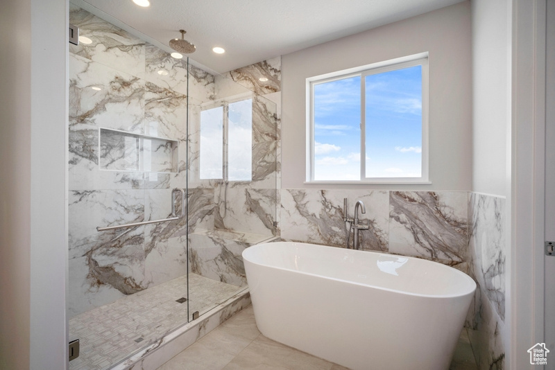 Full bath featuring recessed lighting, tile walls, a marble finish shower, a freestanding bath, and marble finish floor