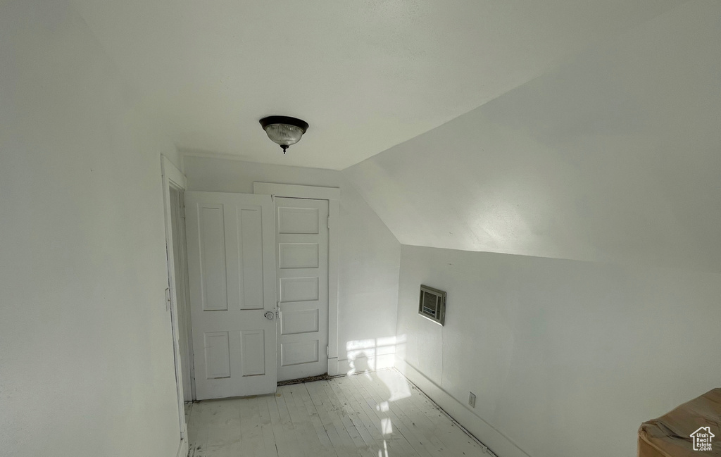 Additional living space with lofted ceiling and baseboards