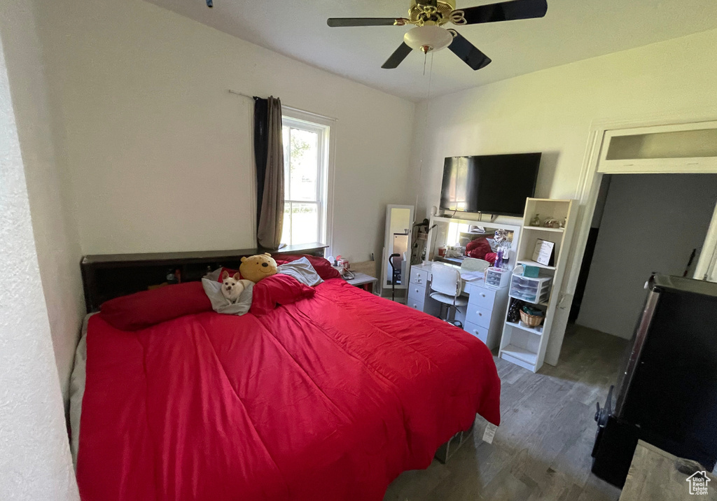 Bedroom with wood finished floors and ceiling fan