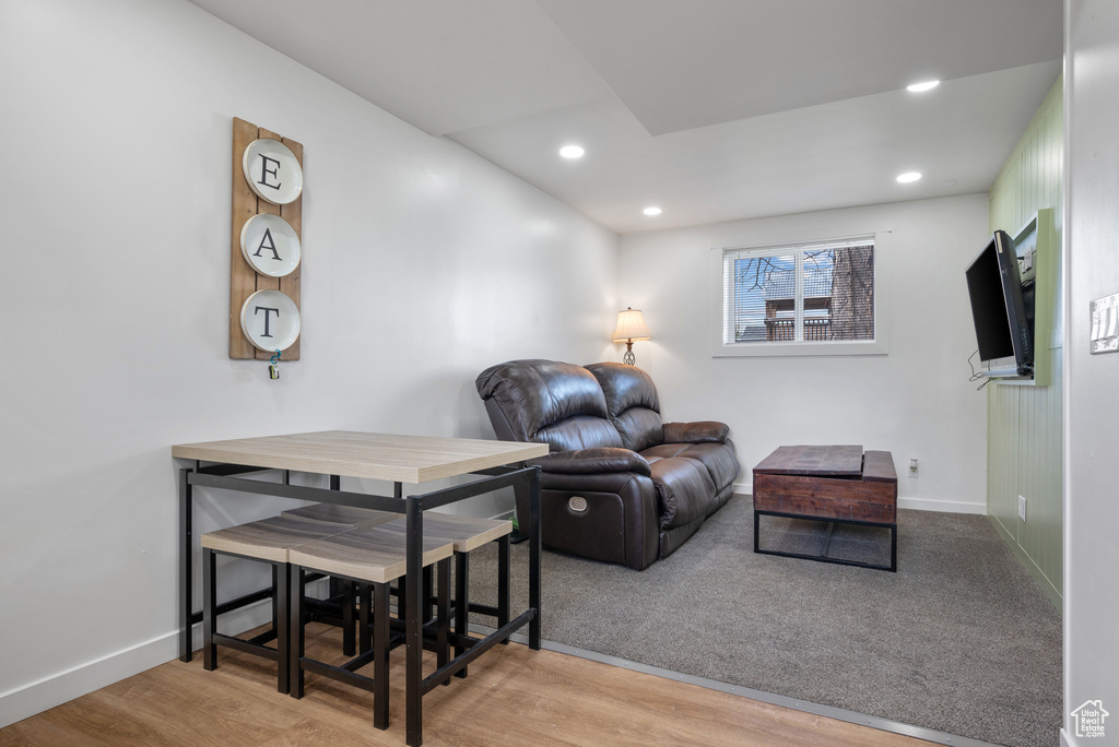 Living room featuring baseboards, wood finished floors, and recessed lighting