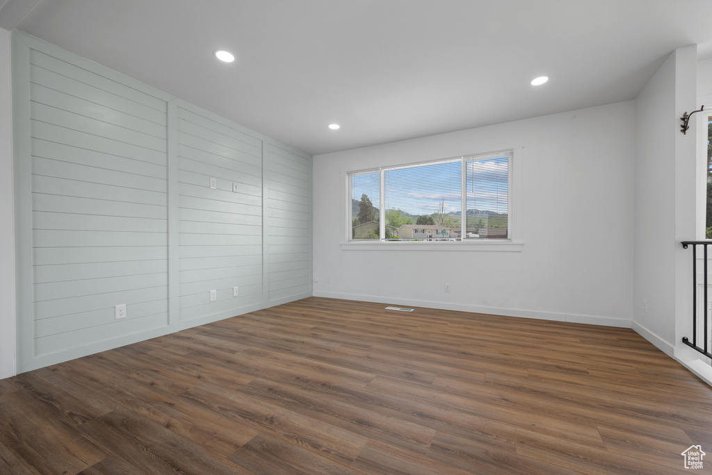 Unfurnished bedroom with recessed lighting, wood finished floors, and baseboards
