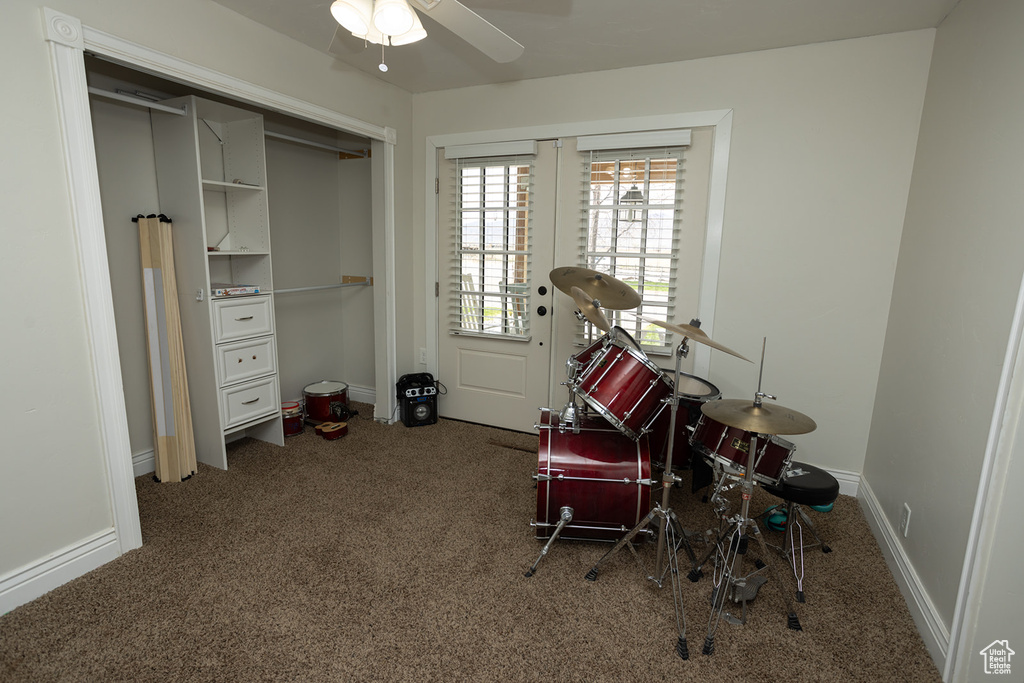 Interior space featuring ceiling fan, carpet, and baseboards