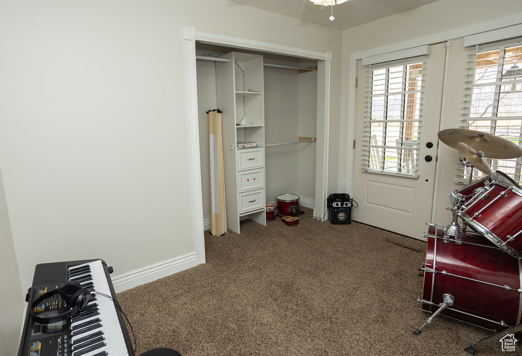 Interior space featuring a closet, baseboards, and carpet floors