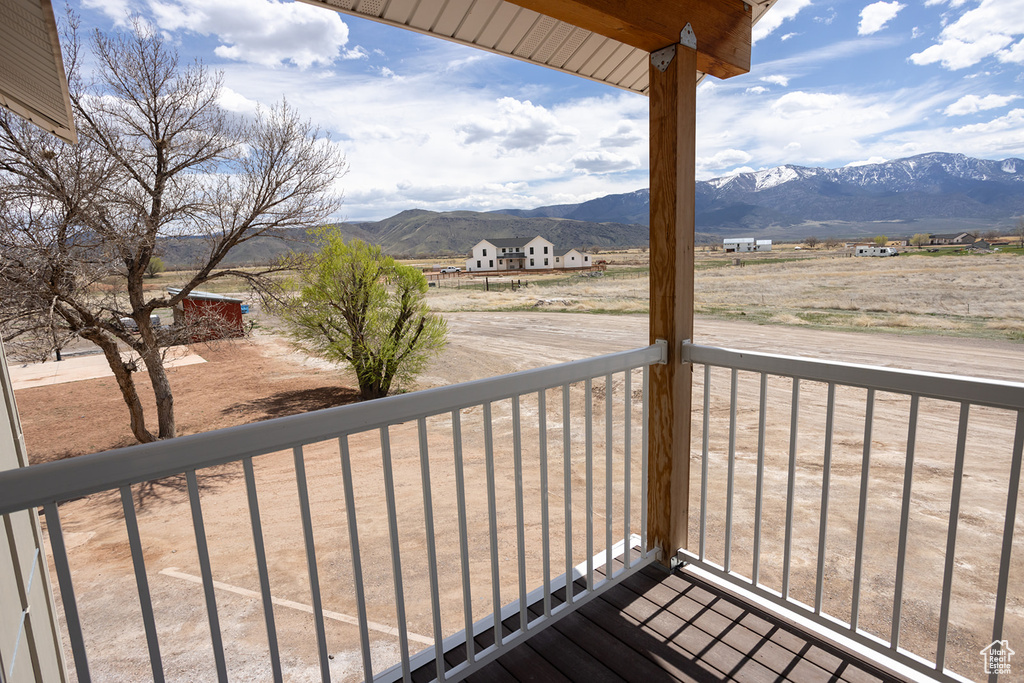 Wooden deck featuring a rural view and a mountain view