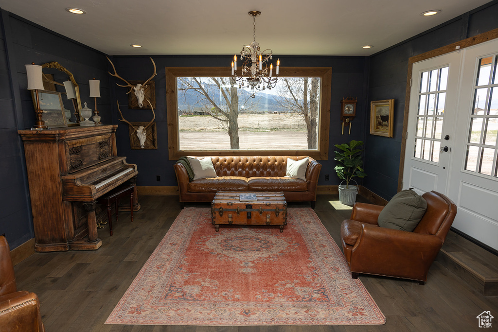 Living area with dark wood-style floors, baseboards, an inviting chandelier, recessed lighting, and french doors