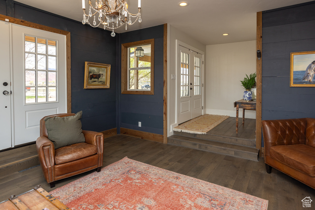 Interior space with baseboards, recessed lighting, wood finished floors, and a notable chandelier