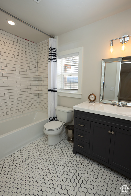 Full bathroom featuring tile patterned floors, shower / bath combo, vanity, and toilet