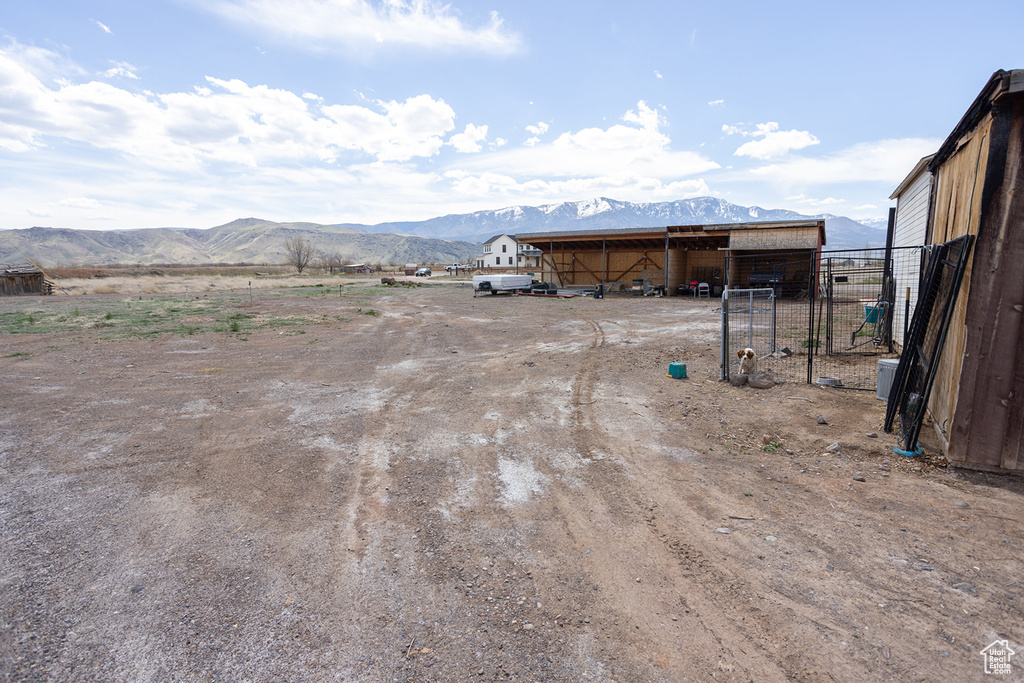 View of yard featuring an outbuilding, a mountain view, and a rural view