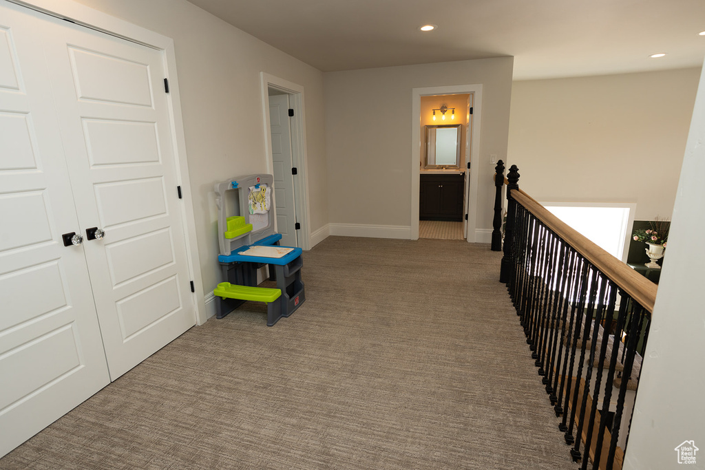 Corridor featuring recessed lighting, an upstairs landing, carpet floors, and baseboards