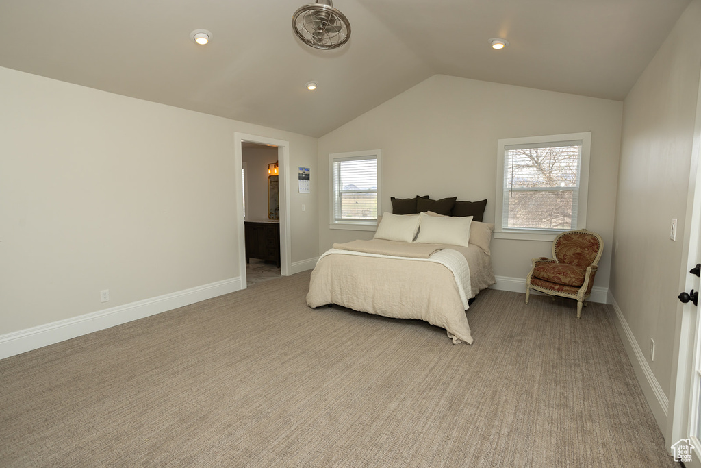 Bedroom featuring light colored carpet, recessed lighting, vaulted ceiling, and baseboards