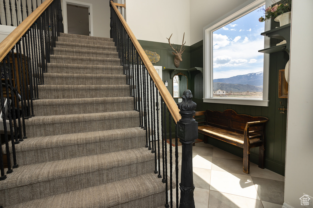 Staircase featuring tile patterned floors