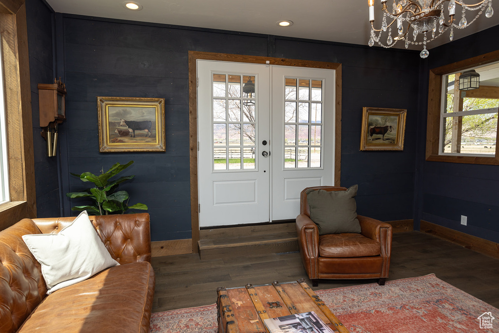 Entryway with baseboards, wood finished floors, a notable chandelier, and french doors