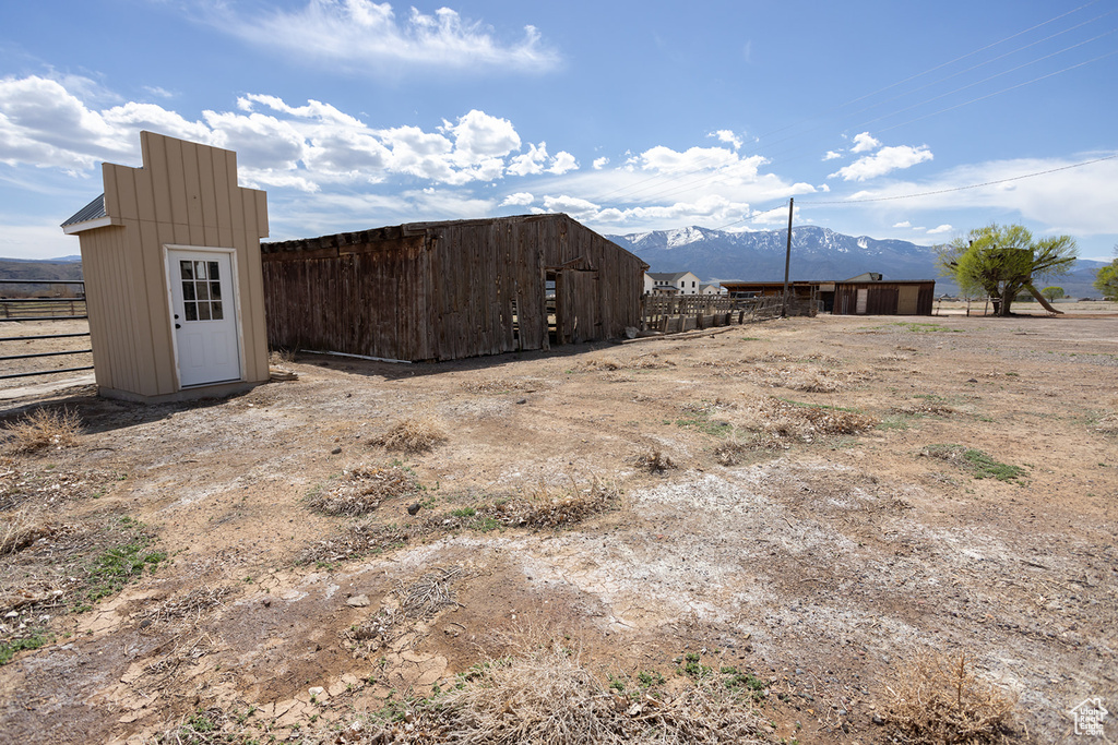 View of yard featuring a mountain view and fence