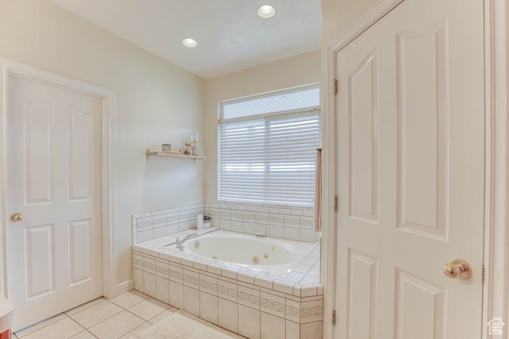 Full bathroom with tile patterned floors, recessed lighting, and a jetted tub