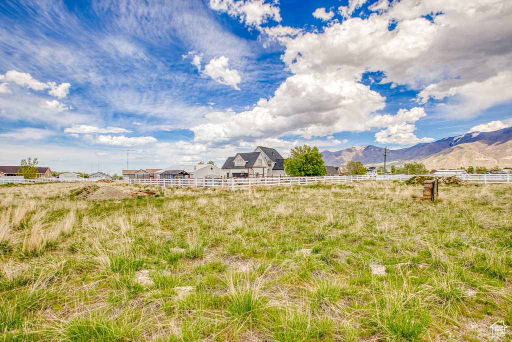 View of yard featuring fence and a mountain view